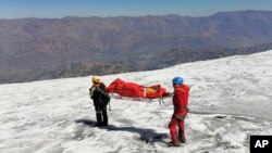 This photo distributed by the Peruvian National Police shows police carrying a body that they identify as U.S. mountain climber William Stampfl, on Huascaran mountain in Huaraz, Peru, July 5, 2024. Stampfl was buried in an avalanche in 2002.