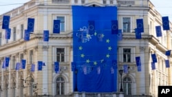 A European Union flag hangs from a building as smaller ones adorn a main street in Sarajevo, Bosnia, March 21, 2024. EU leaders have given a green light to Bosnia-Herzegovina to open membership talks once certain conditions are met.