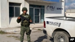 A Mexican army soldier guards the Tamaulipas State Prosecutor's headquarters in Matamoros, Mexico, March 8, 2023. 