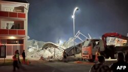 The remains of a collapsed building are seen in George, South Africa, on May 6, 2024. 