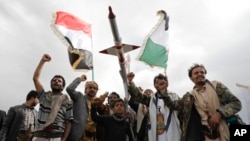 FILE - Houthi supporters attend a rally against the US airstrikes on Yemen and the Israeli offensive against the Palestinians in the Gaza Strip, in Sanaa, Yemen, March 8, 2024.