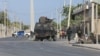 FILE - Security forces patrol outside a building which was attacked by suspected al-Shabab militants in the Somalia's capital Mogadishu, on Feb. 21, 2023.