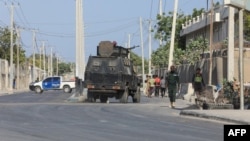 FILE - Security forces patrol outside a building which was attacked by suspected al-Shabab militants in the Somalia's capital Mogadishu, on Feb. 21, 2023.