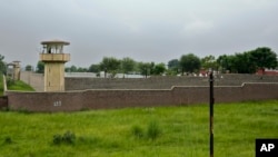 FILE - A guard is seen atop a watch tower at Attock district prison where Pakistan's former Prime Minister Imran Khan is being held and tried, in Attock, Pakistan, Aug. 6, 2023.