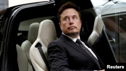 FILE - Tesla Chief Executive Officer Elon Musk gets into a Tesla car as he leaves a hotel in Beijing, China, May 31, 2023.