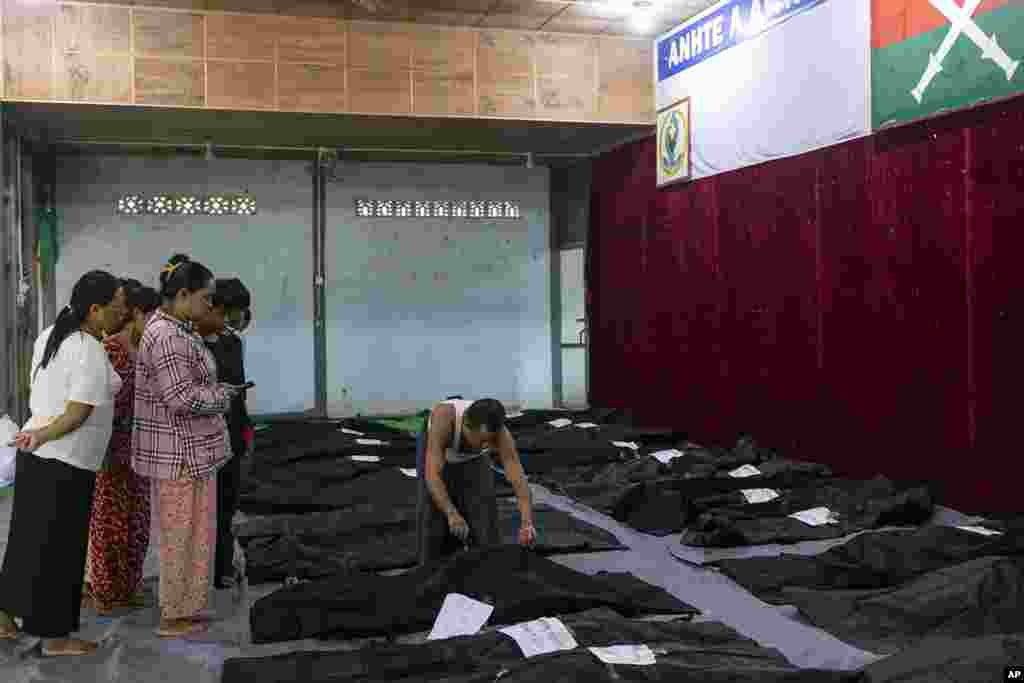 Family members check the bodies of relatives before being buried at a hospital in the town of Laiza, Myanmar.&nbsp;Myanmar&rsquo;s military is accused of launching an airstrike on a camp for displaced persons in the northern state of Kachin that killed about 30 people, including about a dozen children.&nbsp;(AP Photo)