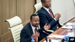 FILE - Ethiopia's Prime Minister Abiy Ahmed, left, accompanied by House speaker Tagesse Chafo, right, addresses the parliament in the capital Addis Ababa, Ethiopia on Nov. 15, 2022.
