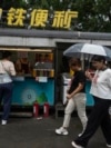 People visit a roadside food stall in Beijing, July 25, 2024.