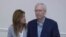 Robbin Taylor, an aide to U.S. Sen. Mitch McConnell, R-Ky., joins McConnell while he speaks at the Madison Event Center, Aug. 30, 2023, in Covington, Ky. McConnell appeared to briefly freeze up, weeks after he had a similar episode in Washington.
