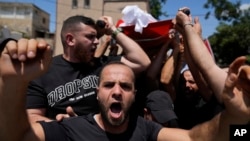 Mourners carry the body of Palestinian Rasheed Mahmoud Sadah, 23, who was killed during a rampage by Israeli settlers, during his funeral in the West Bank village of Jit, near Nablus, Aug. 16, 2024.