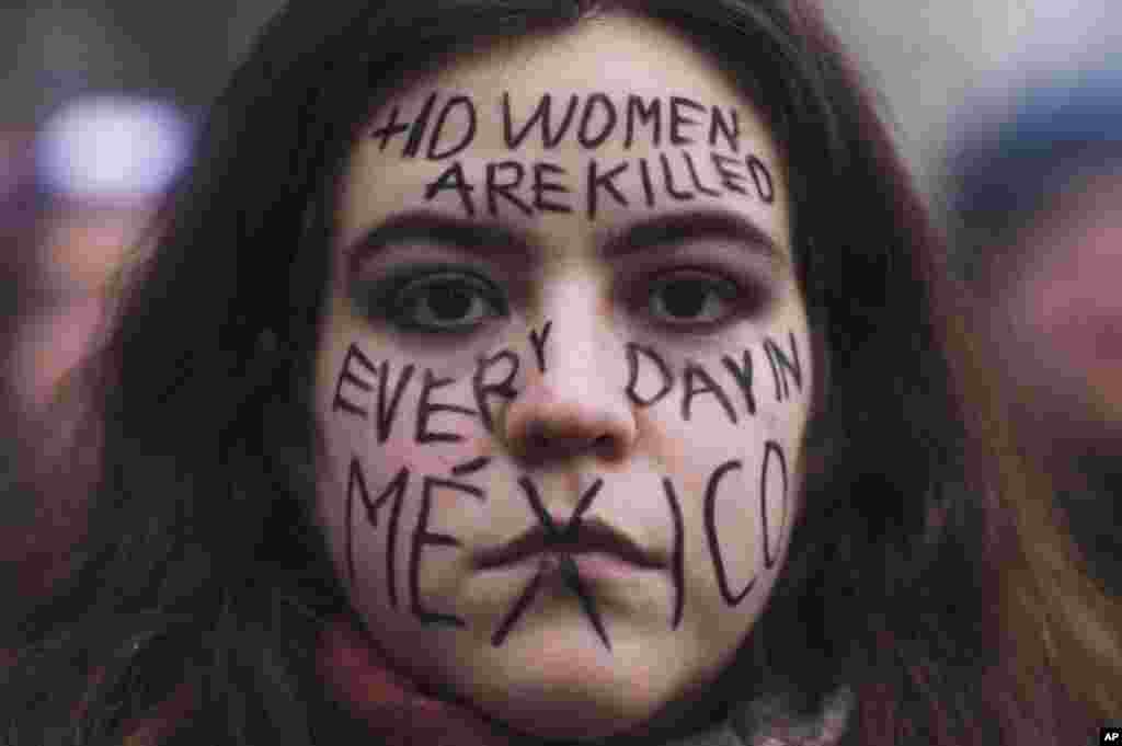 A woman from Mexico with a message draw in her face about the situation in her home country, attends a rally marking International Women&#39;s Day 2023 in Berlin, Germany.