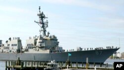 FILE - The USS Mason, an Arleigh Burke-class destroyer, passes a dock in Norfolk, Va., April 8, 2021. 