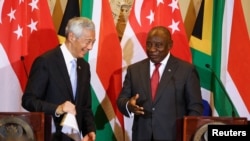 South African President Cyril Ramaphosa, R, and Singapore Prime Minister Lee Hsien Loong attend a media briefing and signing ceremony at Tuynhuys in Cape Town, South Africa, May 16, 2023.