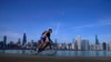 A cyclist pedals around Lake Michigan near the Adler Planetarium, Feb. 26, 2024, in Chicago. 