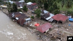 Homes damaged by a flash flood sit in Pesisir Selatan, West Sumatra, Indonesia, March 13, 2024. In Indonesia, environmental groups point to deforestation and environmental degradation worsening the effects of natural disasters such as floods, landslides, drought and forest fires.