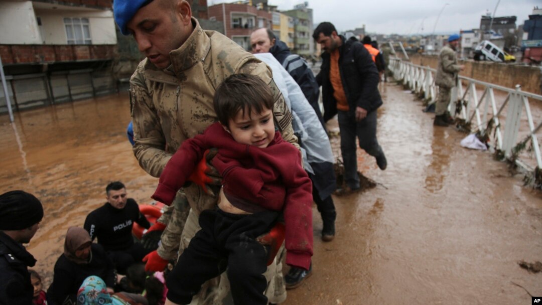 People are rescued during floods after heavy rains in Sanliurfa, Turkey, March 15, 2023. 