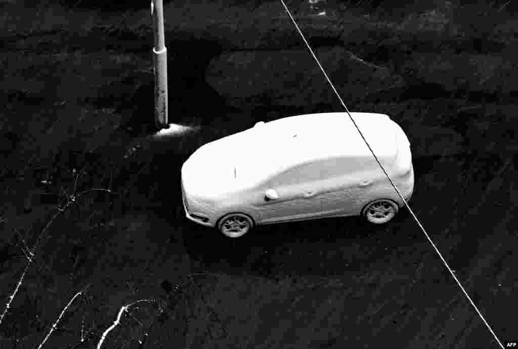 A car is seen covered with snow in the Ukrainian capital, Kyiv.