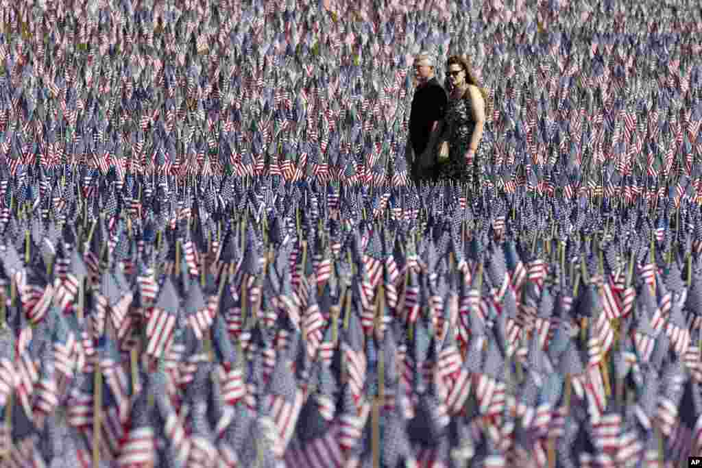 A couple walks through the Memorial Day Flag Garden on Boston Common, May 27, 2023, in Boston, Massachusetts.&nbsp;