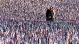 A couple walks through the Memorial Day Flag Garden on Boston Common, May 27, 2023, in Boston. 