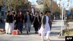 FILE - Male students arrive at the Herat University after the universities were reopened in Herat, Afghanistan, March 6, 2023. 