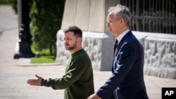 Ukrainian President Volodymyr Zelenskyy, left, welcomes NATO Secretary-General Jens Stoltenberg before their press conference in Kyiv, April 29, 2024.