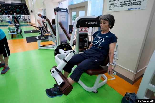 Yasuko Kuroi, 72, uses a leg extension machine as she works out at the Fukagawa Sports Center in Tokyo, Wednesday, June 12, 2024. If you are getting up there in years, weight-resistance training might deliver unexpected benefits. (AP Photo/Hiro Komae)