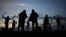 Miserden Morris dancing group performs at sunrise on Rodborough Common, in Stroud, western England, as part of the May Day celebrations.