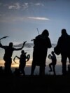 Miserden Morris dancing group performs at sunrise on Rodborough Common, in Stroud, western England, as part of the May Day celebrations.