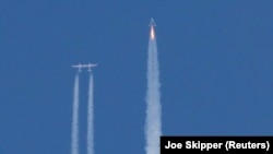 Virgin Galactic's passenger rocket plane VSS Unity, carrying billionaire entrepreneur Richard Branson and his crew, begins its ascent to the edge of space above Spaceport America near Truth or Consequences, New Mexico, U.S., July 11, 2021. REUTERS/Joe Skipper