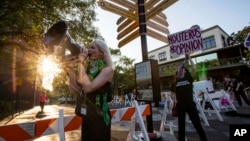 Activists gather outside the Tallahassee City Hall building to protest SB 300, which would place a ban on abortions after six weeks, April 3, 2023, in Tallahassee, Fla. 