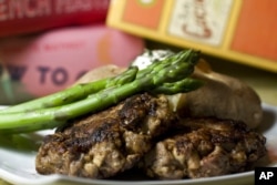 FILE - This photo taken Nov. 15, 2009, shows steak provencale. From Ginette Mathiot's 'I Know How to Cook,' this steak provencale may resemble a hamburger, but one bite shows it's pure French cuisine.