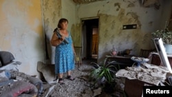 Local resident Yelena Gavrish, 65, stands inside her house damaged by recent shelling in the course of Russia-Ukraine conflict in the village of Rozivka in the Donetsk region, Russian-controlled Ukraine, June 3, 2024.