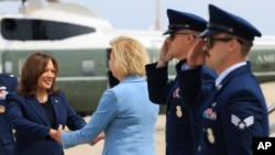 Vice President Kamala Harris, left, is greeted by Democratic Sen. Tammy Baldwin of Wisconsin before boarding Air Force Two to depart on campaign travel to Milwaukee, July 23, 2024 at Andrews Air Force Base, Maryland.