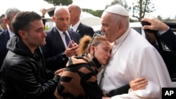 Pope Francis consoles Serena Subania and Matteo Rugghia, left, who lost their 5-year-old daughter Angelica yesterday, as he leaves the hospital in Rome, April 1, 2023.