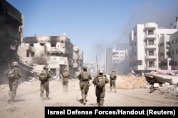 Israeli soldiers operate in the Gaza Strip amid the ongoing conflict between Israel and the Palestinian Islamist group Hamas, in this handout picture released on March 27, 2024.