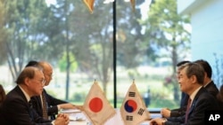 In this photo provided by South Korea Presidential Office, Takeo Akiba, Japan's National Security Adviser, left, meets with Cho Tae-yong, South Korean National Security Adviser, right, in Seoul, South Korea, May 3, 2023.