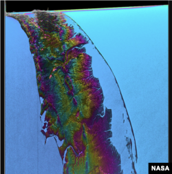 This visualization shows water features on New York’s Long Island – shown as bright pink splotches. Purple, yellow, green, and dark blue shades represent different land elevations, while the surrounding ocean is a lighter blue. (Credit: NASA/JPL-Caltech)