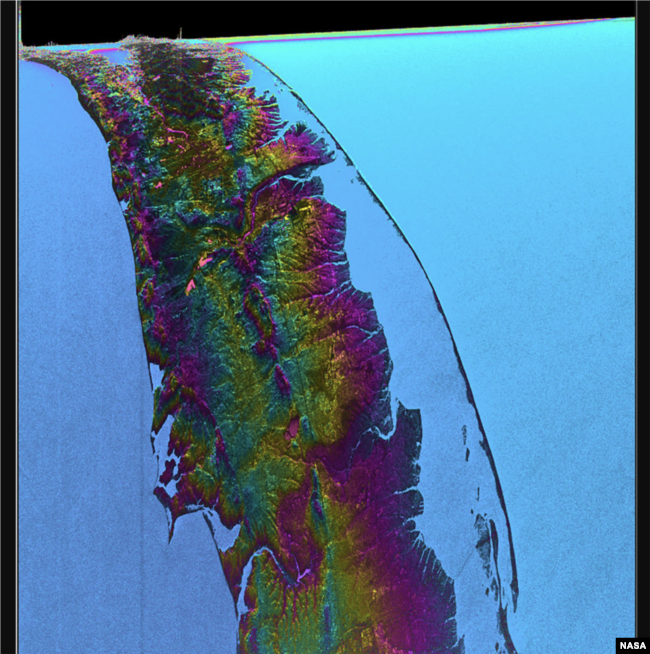 This visualization shows water features on New York’s Long Island – shown as bright pink splotches. Purple, yellow, green, and dark blue shades represent different land elevations, while the surrounding ocean is a lighter blue. (Credit: NASA/JPL-Caltech)