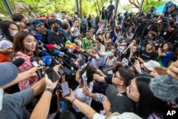 Paetongtarn Shinawatra, left, one of the prime minister candidates from Pheu Thai Party, speaks to media after she cast her vote at a polling station in Bangkok, Thailand, May 14, 2023.