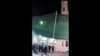 This image grab from a UGC video taken on July 16, 2024, shows people fleeing a shooting at a mosque in the Wadi Kabir area in the east of Oman's capital Muscat. 