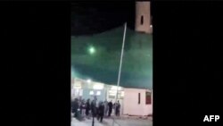 This image grab from a UGC video taken on July 16, 2024, shows people fleeing a shooting at a mosque in the Wadi Kabir area in the east of Oman's capital Muscat. 