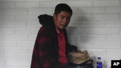 Rigoberto Roman Miranda Orozco, who allegedly helped coordinate a human smuggling effort that ended with 53 migrants dead, sits in a cell at a courtroom in Guatemala City, Aug. 21, 2024.