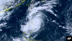 This satellite image provided by courtesy of the National Institute of Information and Communications Technology (NICT) shows Typhoon Saola moving north towards Taiwan, Aug. 29, 2023. 