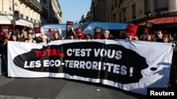 FILE: Environmental activists protest against TotalEnergies and the East African Crude Oil Pipeline (EACOP) on the day TotalEnergies holds its annual shareholders meeting in Paris, France, on May 26, 2023. 
