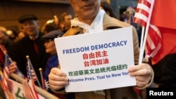 A supporter holds a sign while Taiwan's President Tsai Ing-wen arrives at the Lotte Hotel in New York on March 29, 2023.