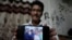 Gautam Dongre, of the National Alliance of Sickle Cell Organizations, shows a photograph his family, including his son, Girish, second left, and daughter, Sumedha, right, both patients with sickle cell disease, in Nagpur, India, Dec. 6, 2023.