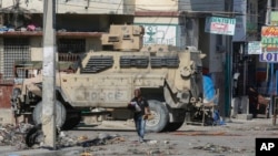 FILE - An armored police car patrols the General Hospital area in Port-au-Prince, Haiti, April 2, 2024.