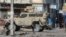 FILE - An armored police car patrols the General Hospital area in Port-au-Prince, Haiti, April 2, 2024.