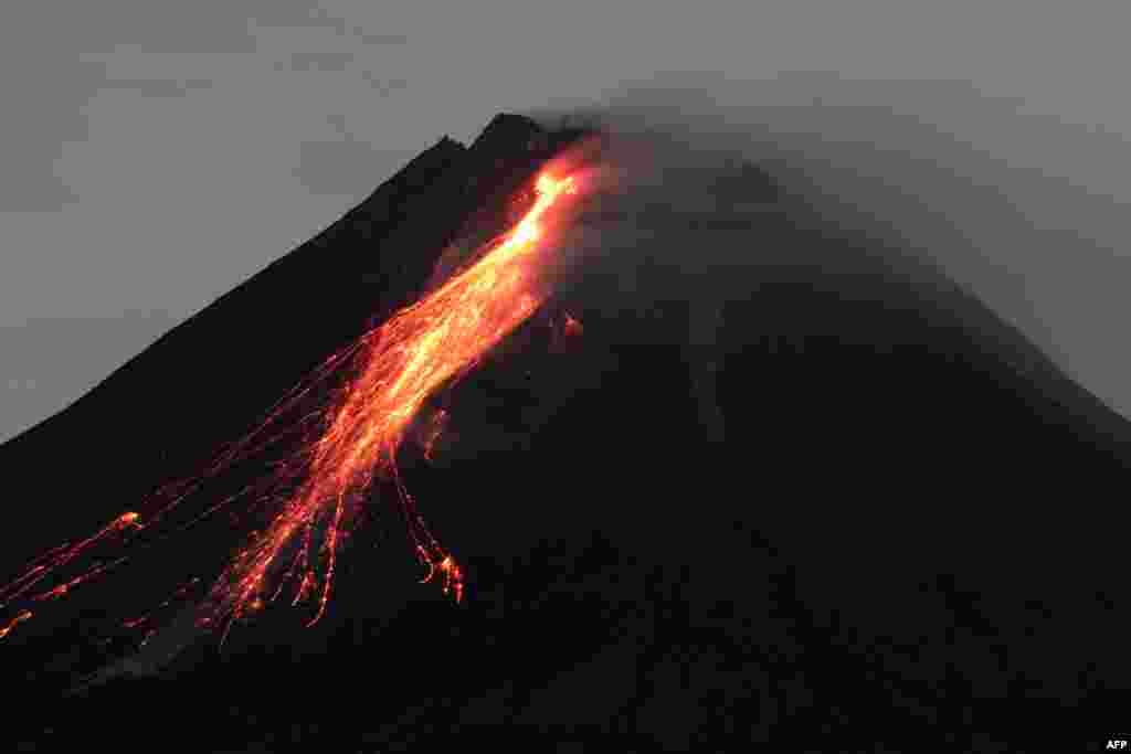 This picture taken from the Wonokerto village in Sleman, Yogyakarta, shows mount Merapi releasing hot lava.