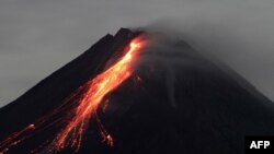 This picture taken from the Wonokerto village in Sleman, Yogyakarta, shows mount Merapi releasing hot lava.